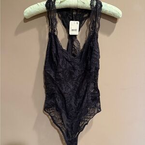 New with tags Free People brand black lace bodysuit in size large.